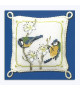 Cross-stitched pin cushion, decorated with blue tits and white flowers. Textile Heritage Collection.
