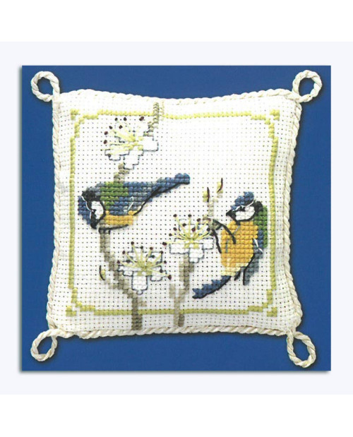 Cross-stitched pin cushion, decorated with blue tits and white flowers. Textile Heritage Collection.