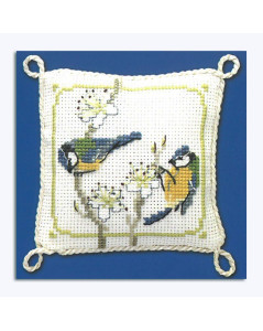 Cross-stitched pin cushion, decorated with blue tits and white flowers. Textile Heritage Collection.